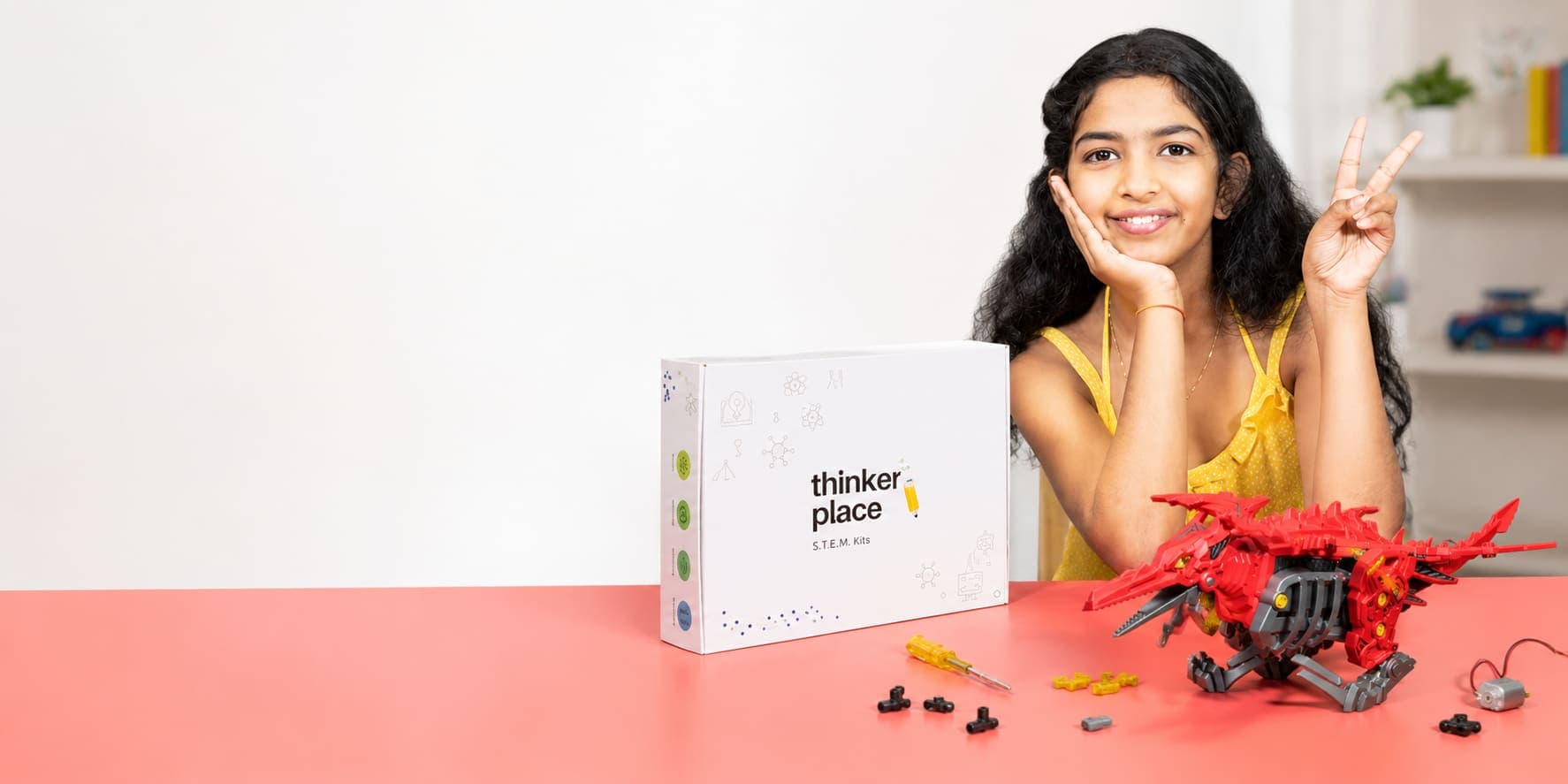A child building and soldering a ThinkerPlace STEM kit
